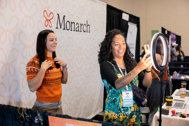 Content Creators Using a Ring Light and IPhone to Make Content at a Conference Booth